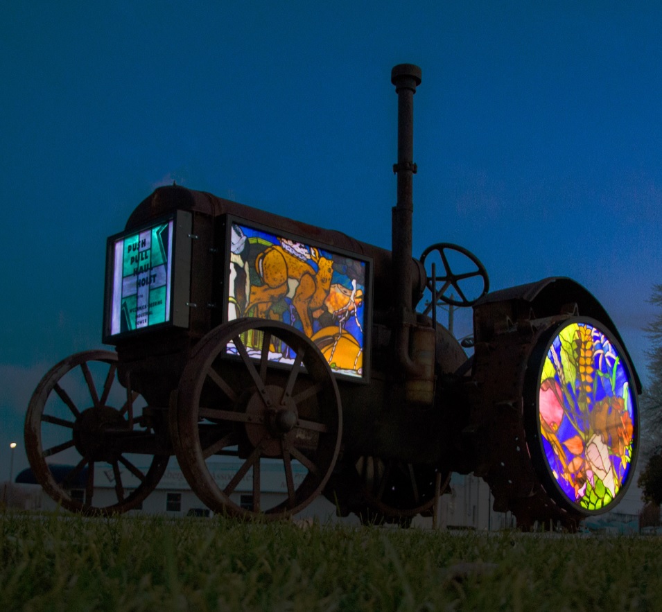 Rustician (hunt & gather ... seek & find) stained glass tractor by Karl Unnasch. Photo by Kristi Fernholz.